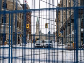 Fencing is erected on Metcalfe Street near Parliament Hill as police worked to evict the last of the trucks and supporters occupying the downtown core, three weeks after a protest against COVID-19 vaccine mandates began in Ottawa, Feb. 20, 2022.