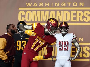 Former players look at the new uniforms during the announcement of the Washington Football Team's name change to the Washington Commanders at FedExField on Feb. 2, 2022 in Landover, Maryland.