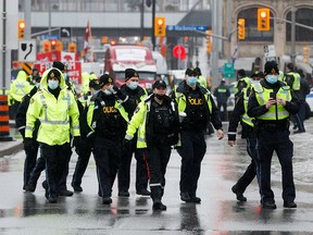 Police officers patrol on Wellington Street, as truckers and supporters continue to protest vaccine mandates, in Ottawa February 17, 2022.