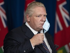Ontario Premier Doug Ford arrives to his press conference at Queen’s Park regarding the easing of restrictions during the COVID-19 pandemic in Toronto on Thursday, January 20, 2022.