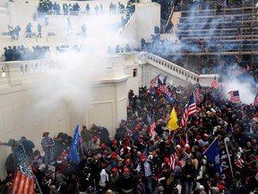 Police release tear gas into a crowd of pro-Trump protesters during clashes at a rally to contest the certification of the 2020 U.S. presidential election results by the U.S. Congress, at the U.S. Capitol Building in Washington, D.C., Jan. 6, 2021.