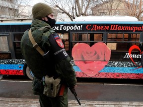 A militant of the self-proclaimed Donetsk People's Republic stands outside a military mobilization point in the separatist-controlled city of Donetsk, Ukraine February 23, 2022.
