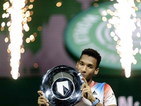 Canada's Felix Auger-Aliassime poses with the trophy as he celebrates after victory over Greece's Stefanos Tsitsipas  at the ABN AMRO World Tennis Tournament in Ahoy Rotterdam in Rotterdam on February 13, 2022.