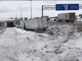 A transport in the ditch on the Highway 401 westbound express lanes ramp to Hurontario on Thursday, Feb. 3, 2022.