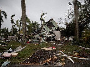Debris lies scattered around a home after a tornado touched down in Fort Myers, Florida on January 16, 2022.