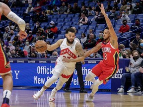 Raptors' Fred VanVleet  dribbles against New Orleans Pelicans' CJ McCollum during the first half at the Smoothie King Center on Monday, Feb. 14, 2022.