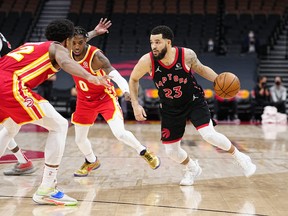 Toronto Raptors guard Fred VanVleet (23) drives to the net against Atlanta Hawks forward De'Andre Hunter (12) and guard Delon Wright (0) during the second half at Scotiabank Arena.
