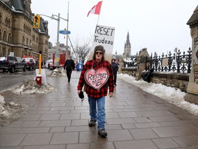 A demonstrator with the Freedom Convoy is pictured on Wellington Street in Ottawa on Feb. 10, 2022.