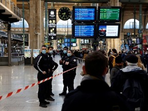 French police secure the scene after officers killed a person who attacked them with a knife at Gare du Nord station in Paris, Monday, Feb. 14, 2022.