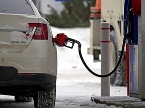 A motorist fills up with gas at an Esso station on Friday, Feb. 4, 2022.