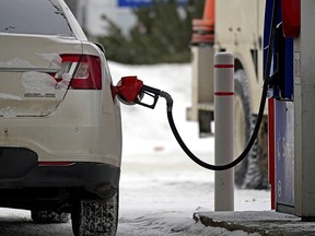 A motorist fills up with gas at an Esso station on Friday February 4, 2022.