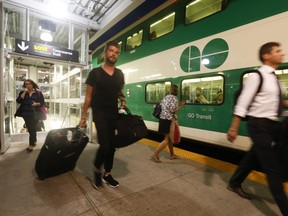 GO Train commuters board an eastbound train at Union Station on  Thursday, Sept. 10, 2015.