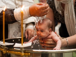 A child being baptized.