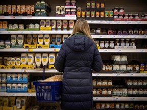 A customer shops for mayonnaise and condiments at a Sainsbury's supermarket in Walthamstow, east London on Feb. 13, 2022.