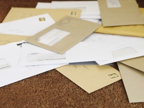 A pile of mail on a doormat.