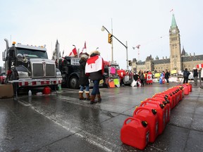 Empty jerry cans line the street in front of parked trucks as demonstrators continue to protest the Covid-19 vaccine mandates implemented by Prime Minister Justin Trudeau on February 9, 2022, in Ottawa, Canada. (Photo by Dave Chan / AFP) (Photo by DAVE CHAN/AFP via Getty Images)