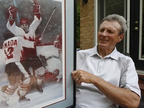 Legendary Team Canada 1972 Summit Series hero Paul Henderson poses with a print of "The Goal" in his Mississauga backyard.