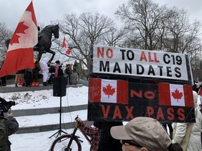 A pocket of the downtown core around Queen’s park remained blocked or partially blocked by police cruisers, buses, and municipal dump trucks as supporters of the trucker convoy protest gathered in the centre of Queen’s Park to again denounce pandemic mandates.