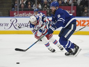 Maple Leafs defenceman Jake Muzzin goes after a loose puck against the New York Rangers. Muzzin is close to a return to action.