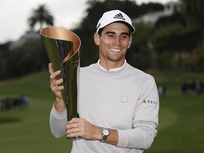Joaquin Niemann of Chile celebrates with the trophy during the trophy ceremony after winning during the final round of The Genesis Invitational at Riviera Country Club on Feb. 20, 2022 in Pacific Palisades, Calif.
