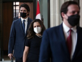 Canadian Prime Minister Justin Trudeau (left) arrives for a news conference on Monday, Feb. 21, 2022 in Ottawa.