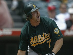 Athletics left fielder Jeremy Giambi watches the flight of the ball during a game against the Angels in Anaheim, Calif., April 14, 2002.