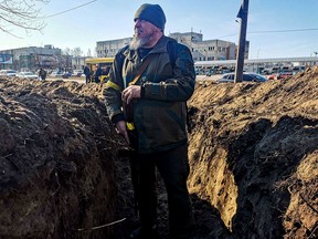 A Kyiv resident and volunteer prepares a rear post with trenches, in Kyiv on February 28, 2022.