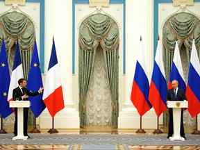 Russian President Vladimir Putin, right, listens during a joint press conference with French President Emmanuel Macron in Moscow, on Feb. 7, 2022.