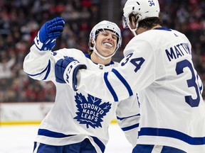 Toronto Maple Leafs right wing Mitch Marner (16) celebrates with centre Auston Matthews (34) after scoring his third goal of the game during the second period against the Detroit Red Wings at Little Caesars Arena.