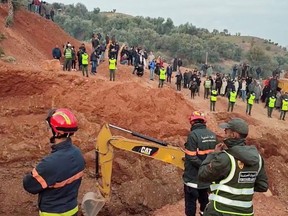 People use machinery to excavate the ground in order to free a boy trapped in an underground well, in Chefchaouen, Morocco, Feb. 4, 2022, in this screen grab obtained from a social media video.