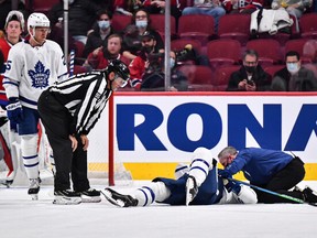 Medical staff tend to Maple Leafs defenceman Jake Muzzin during the second period of Monday's game against the Montreal Canadiens.