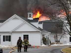 Firefighters battle a blaze that struck the Oakland Hills Country Club, which has hosted several golf majors in the past years, in Bloomfield Township, Michigan February 17, 2022.