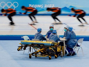Medical staff in personal protective equipment are seen at a speed skating training session for the Beijing 2022 Winter Olympics in Beijing, China, January 28, 2022. REUTERS/Tyrone Siu