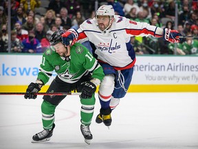Washington Capitals left wing Alex Ovechkin (8) and Dallas Stars centre Luke Glendening (11) chase the puck at the American Airlines Center.