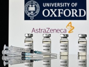 An illustration picture shows vials with Covid-19 Vaccine stickers attached and syringes, with the logo of the University of Oxford and its partner British pharmaceutical company AstraZeneca, on November 17, 2020.