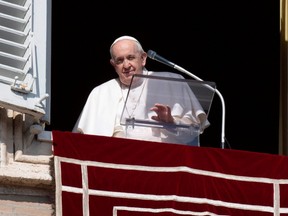 Pope Francis leads the Angelus prayer from the window of the Apostolic Palace at the Vatican, Sunday, Feb. 6, 2022.