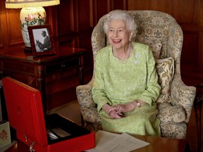 A file Buckingham Palace handout image released on Feb. 6, 2022, shows Queen Elizabeth II smiling as she sits in Sandringham House in Norfolk, eastern England on Feb. 2, 2022, released to mark the start of Her Majesty's Platinum Jubilee Year.
