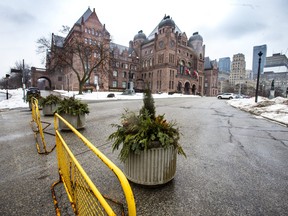 Heavy planters are seen along the perimeter of Queen’s Park in Toronto, Ont. on Wednesday, Feb. 2, 2022. The planters were placed to serve as potential barriers ahead of a potential truckers' rally on Saturday.