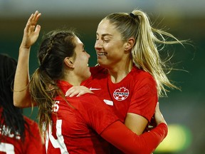 Canada's Janine Beckie, right, and Vanessa Gilles celebrates a goal against Germany at the Arnold Clark Cup in Norwich, England on Feb. 20, 2022.