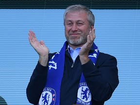 Chelsea's Russian owner Roman Abramovich applauds, as players celebrate their league title win at the end of the Premier League football match between Chelsea and Sunderland at Stamford Bridge in London on May 21, 2017.