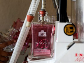 A staff member at Indlovu Gin fills bottles of Indlovu gin during the bottling process, in Paarl, near Cape Town, South Africa, January 28, 2022.