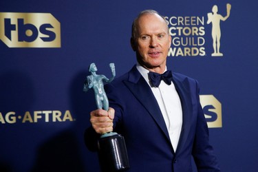Actor Michael Keaton poses backstage with the award for Outstanding Performance by a Male Actor in a Television Movie or Limited Series at the 28th Screen Actors Guild Awards, in Santa Monica, Calif, Sunday, Feb. 27, 2022.