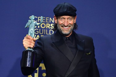 U.S. actor Troy Kotsur poses with his award for Outstanding Performance by a Male Actor in a Supporting Role for for his performance in CODA in the press room during the 28th Annual Screen Actors Guild Awards at the Barker Hangar in Santa Monica, Calif., Sunday, Feb. 27, 2022.