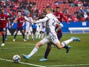 Toronto FC forward Jacob Shaffelburg (22) crosses the ball during the first half against FC Dallas at Toyota Stadium in the Reds' season opener on Saturday.