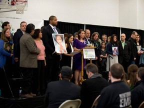 In this file photo taken Jan. 14, 2013, family members of victims of the Sandy Hook Elementary School shooting attend a news conference in Newtown, Conn.