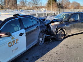 The Ontario Provincial Police say a cruiser was hit by a car while an officer was investigating a minor collision.