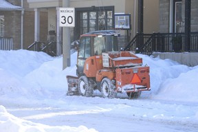 A City of Toronto plow clears the sidewalks in a residential area in East York on Ferris Rd., east of Dawes Rd., on Tuesday, January 25, 2022. Jack Boland/Toronto Sun