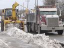Three weeks after the 2022 blizzard, the City of Toronto was still clearing ice and snow from the curb lanes along Gerrard Street East, just west of Victoria Park Avenue, on Tuesday 8 February 2022. 