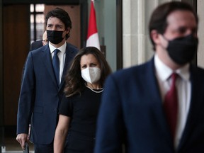 Prime Minister Justin Trudeau (left) arrives for a news conference on February 21, 2022 in Ottawa, Canada.