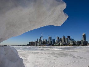Snow frames the Toronto skyline from the end of Polson St. on Saturday, Jan. 29, 2022.